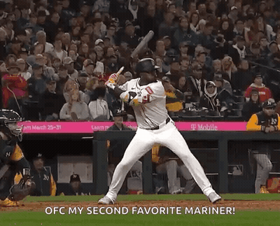 A Baseball Player Is Swinging A Bat At A Ball And Says Ofc My Second Favorite Mariner GIF