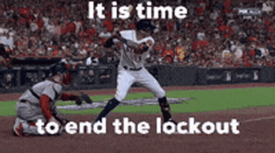 A Baseball Player Is Swinging A Bat At A Ball While A Catcher Looks On . GIF