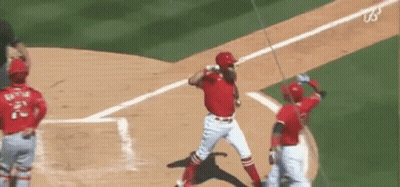A Baseball Player Is Swinging A Bat At A Ball While A Catcher Watches . GIF