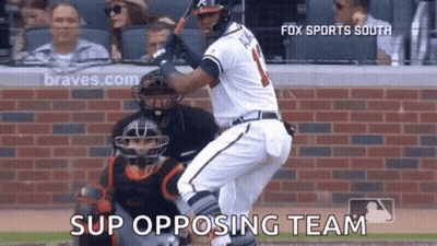A Baseball Player Is Swinging A Bat At A Ball While A Catcher Watches On . GIF