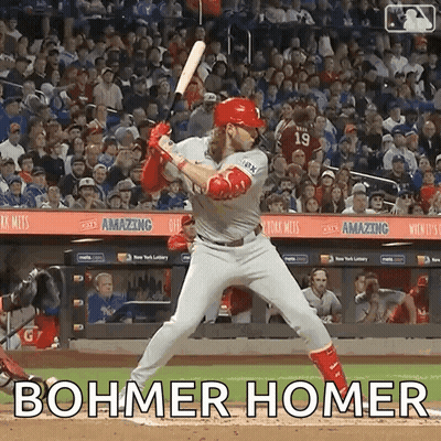 A Baseball Player Is Swinging A Bat At A Ball With The Words Bohmer Homer Written On The Field . GIF