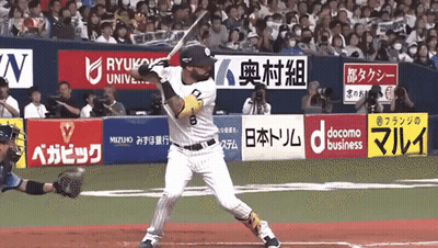 A Baseball Player Is Swinging At A Ball In Front Of A Banner That Says Docomo Business GIF