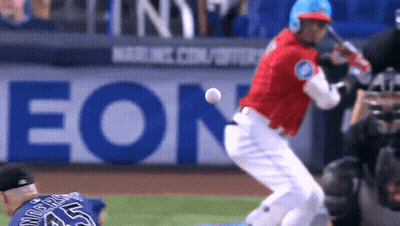 A Baseball Player Is Swinging At A Ball With An Eon Ad In The Background GIF