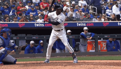 A Baseball Player Is Swinging At A Pitch In Front Of A Banner That Says Twins GIF