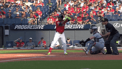 A Baseball Player Is Swinging At A Pitch In Front Of A Progressive Banner GIF