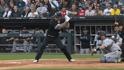 A Baseball Player Is Swinging At A Pitch In Front Of A Sign That Says Securan GIF