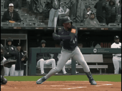 A Baseball Player Is Swinging At A Pitch In Front Of A Wall That Says Milwaukee Astros GIF