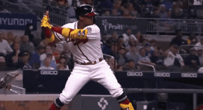 A Baseball Player Is Swinging At A Pitch In Front Of A Wellstar Sign GIF