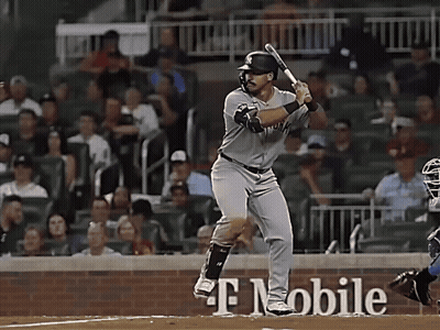 A Baseball Player Is Swinging His Bat In Front Of A T Mobile Sign GIF