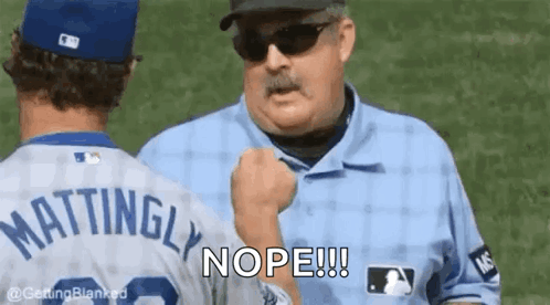 A Baseball Player Is Talking To A Referee Who Is Holding His Fist Up . GIF