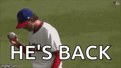 A Baseball Player Is Throwing A Ball And The Words `` He 'S Back '' Are Written On The Screen . GIF