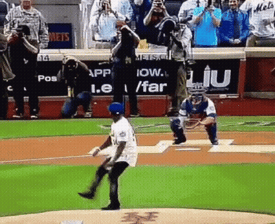 A Baseball Player Is Throwing The First Pitch Of A Game While A Catcher Watches . GIF