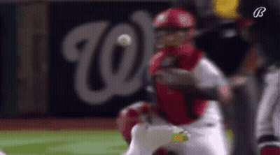 A Baseball Player Is Trying To Catch A Ball While A Catcher Is Trying To Catch The Ball . GIF
