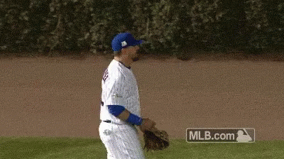 A Baseball Player Is Walking On The Field With A Mlb.com Sign In The Background GIF