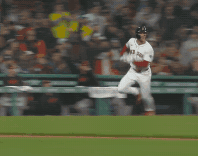 A Baseball Player Laying On The Ground In Front Of A Coca Cola Ad GIF