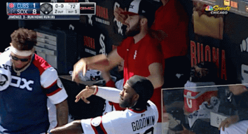 A Baseball Player Named Goodwin Is Being Hugged By Another Player GIF