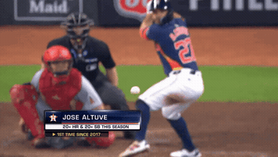 A Baseball Player Named Jose Altuve Is Swinging At The Ball GIF