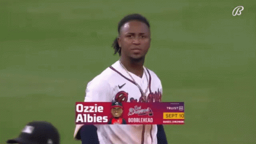 A Baseball Player Named Ozzie Albies Is Standing On A Field GIF