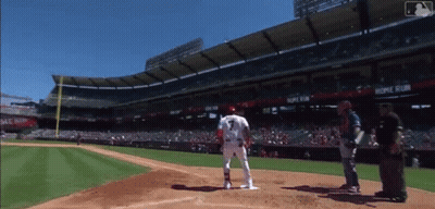 A Baseball Player Stands At Home Plate In Front Of A Stadium That Says Home Run On It GIF