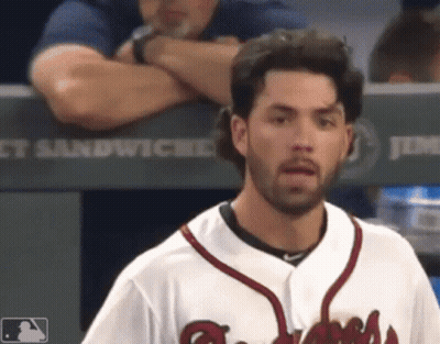A Baseball Player Stands In Front Of A Dugout That Says Jimmy Sandwiches GIF