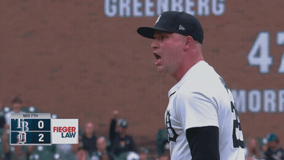 A Baseball Player Stands In Front Of A Scoreboard That Says Fieger Law On It GIF