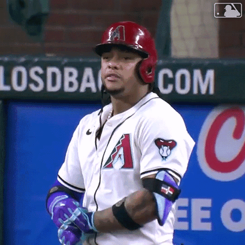 A Baseball Player Stands In Front Of A Sign That Says Losdback.com GIF