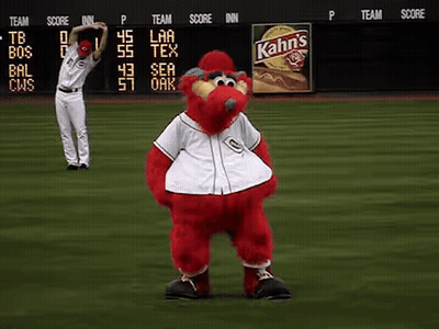 A Baseball Player Stretches His Arms In Front Of A Kahn 'S Sign GIF
