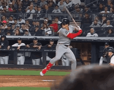 A Baseball Player Swings At A Pitch In Front Of A Bank Of America Sign GIF
