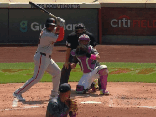 A Baseball Player Swings His Bat At A Ball In Front Of A Wall That Says Citi Field GIF