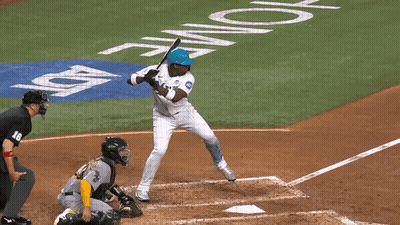 A Baseball Player Swings His Bat At A Pitch In Front Of A Home Plate GIF