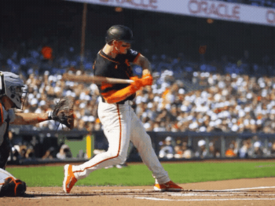 A Baseball Player Swings His Bat At A Pitch In Front Of An Oracle Banner GIF