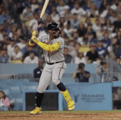 A Baseball Player Swings His Bat At A Pitch GIF