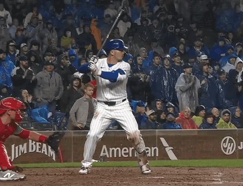 A Baseball Player Swings His Bat In Front Of A Beam America Sign GIF