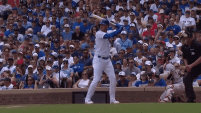 A Baseball Player Swings His Bat In Front Of A Crowd Wearing A Jersey That Says ' Chicago ' On It GIF