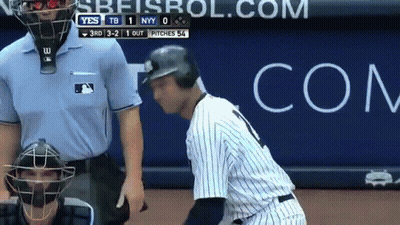A Baseball Player Talking To A Referee In Front Of A Com Advertisement GIF
