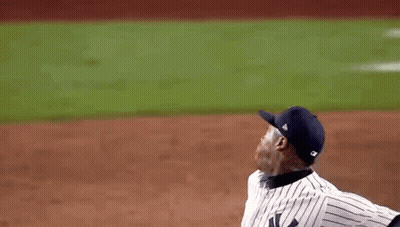 A Baseball Player Throws A Ball While Wearing A New York Yankees Jersey GIF
