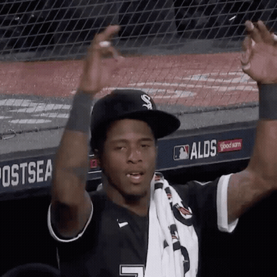 A Baseball Player Wearing A Black Hat And A White Scarf With The Number 7 On It GIF