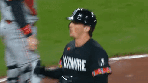 A Baseball Player Wearing A Black Jersey That Says ' Baltimore ' On It GIF