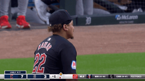 A Baseball Player Wearing A Black Jersey With The Number 22 On It GIF