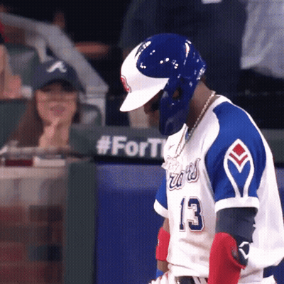 A Baseball Player Wearing A Blue And White Jersey With The Number 13 On It GIF