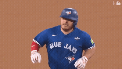 A Baseball Player Wearing A Blue Jays Uniform Is Running On The Field . GIF