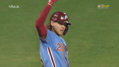 A Baseball Player Wearing A Blue Jersey With The Number 28 On The Front GIF