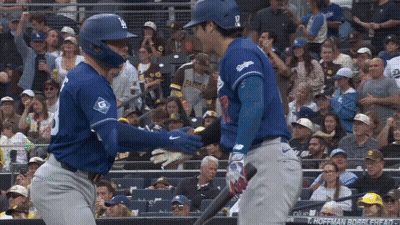 A Baseball Player Wearing A Blue Jersey With The Number 9 On It GIF