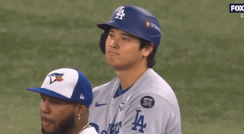 A Baseball Player Wearing A Blue La Helmet Looks To The Side GIF