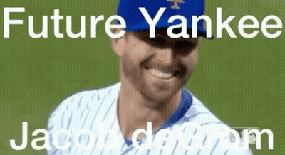 A Baseball Player Wearing A Blue Yankees Hat Is Smiling On A Field . GIF