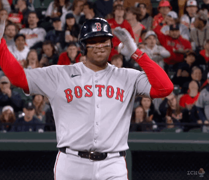 A Baseball Player Wearing A Boston Jersey Holds His Arms Up In The Air GIF