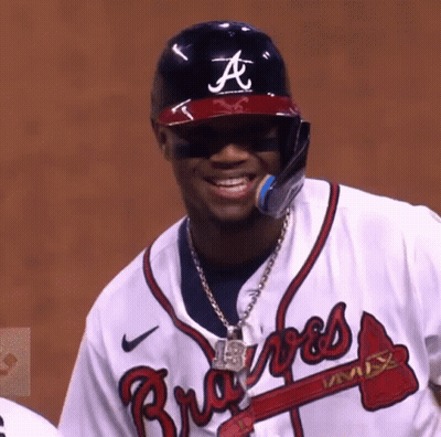 A Baseball Player Wearing A Braves Jersey And A Helmet GIF