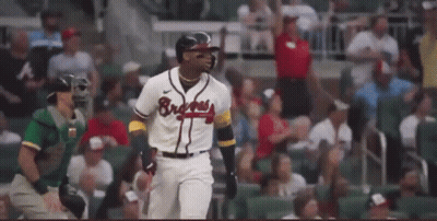 A Baseball Player Wearing A Braves Jersey Is Running Towards Home Plate During A Game . GIF