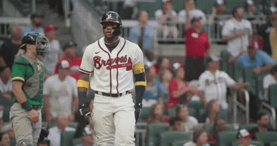 A Baseball Player Wearing A Braves Jersey Stands In Front Of A Crowd GIF