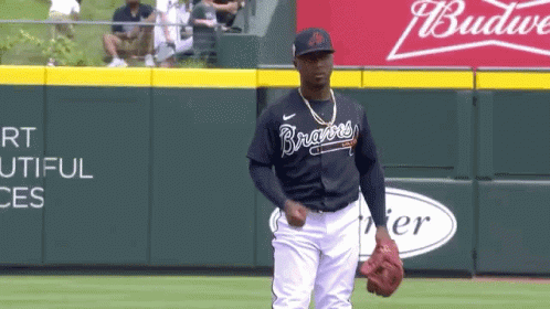 A Baseball Player Wearing A Braves Jersey Stands On A Field GIF